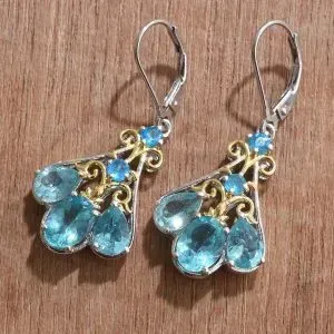 Pairaba apatite dangle earrings in sterling silver with gold accents.