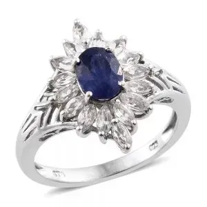 Sapphire halo ring against white background.