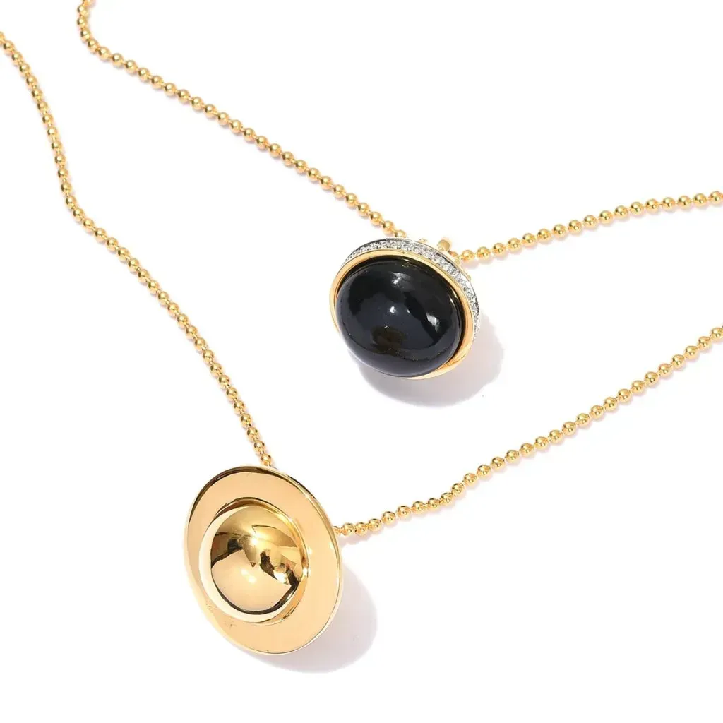 Gold necklace with dark stone.