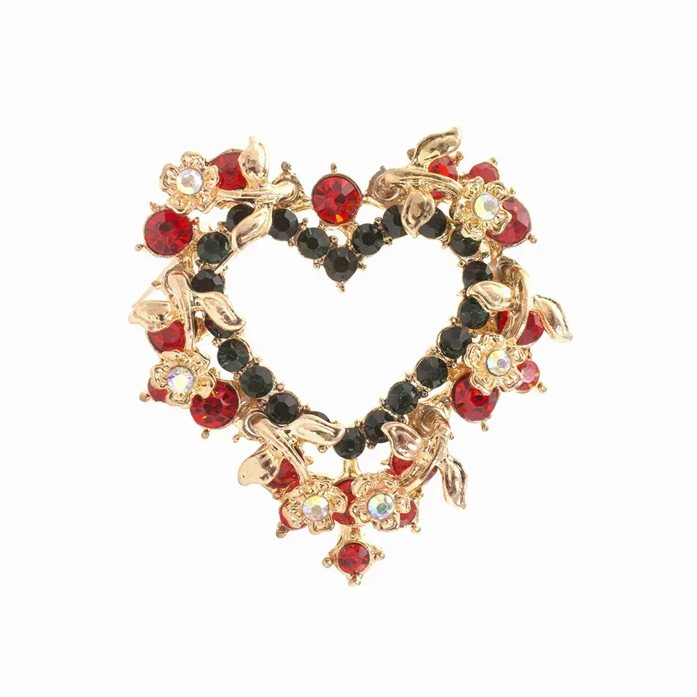 Closeup of flower heart brooch against white background