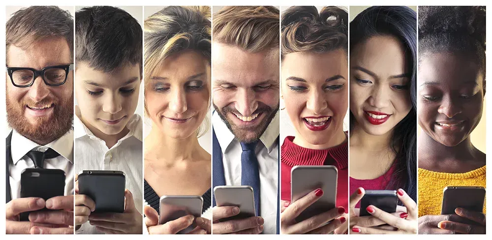 People looking happily at their phones.