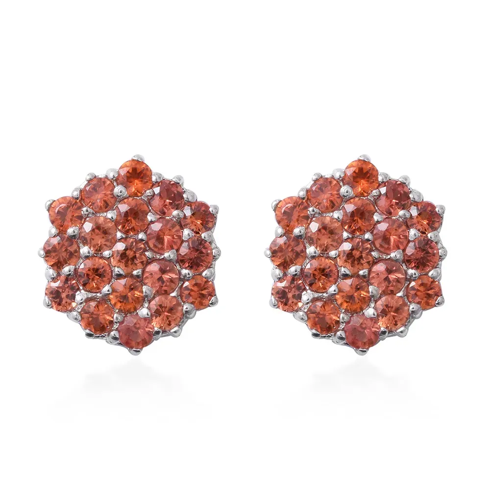 Closeup of orange sapphire cluster earrings