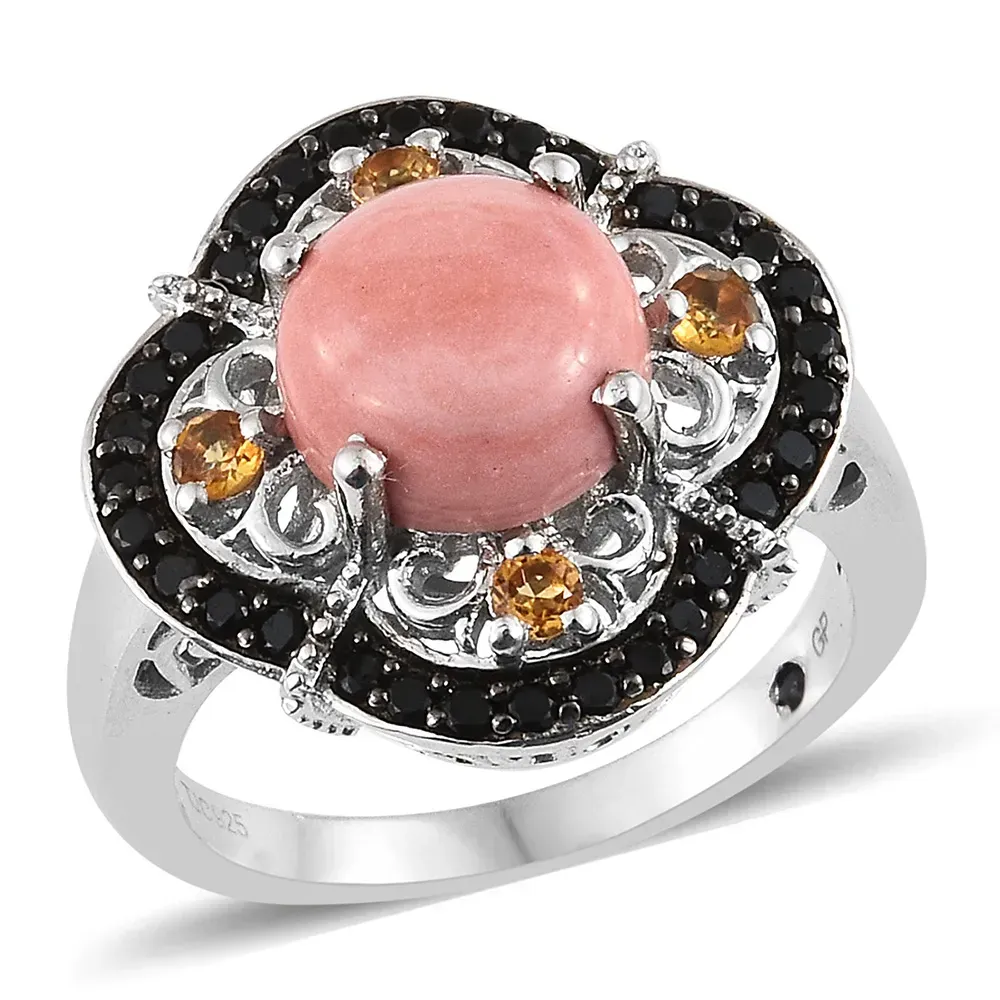 Closeup of pink stone ring with black setting and silver band