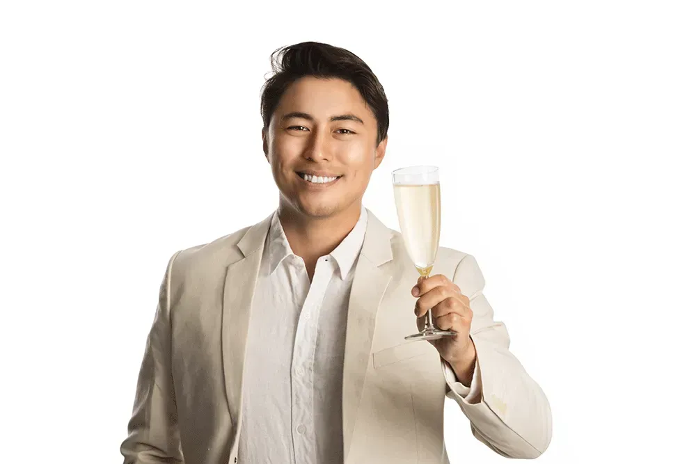 Man holding champagne glass with champagne colored blazer