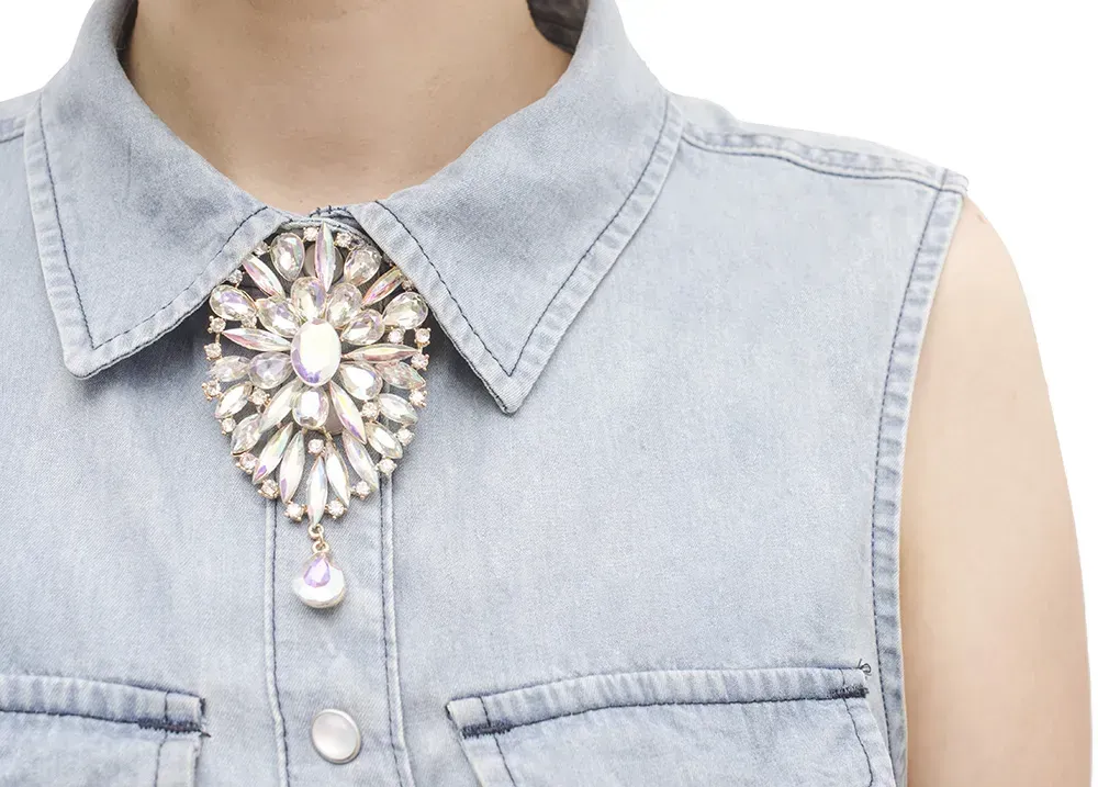 Closeup of faux necklace on denim top