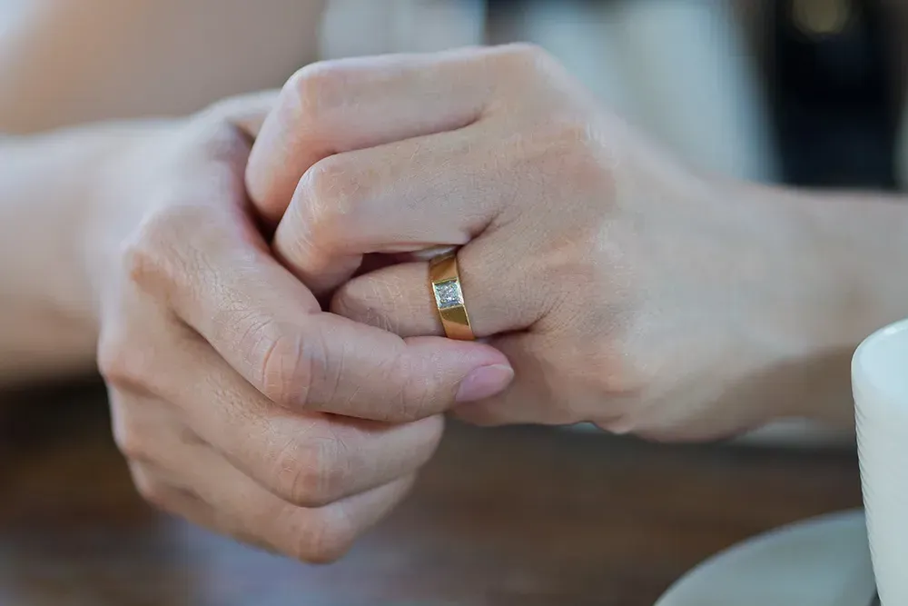 Closeup of a man fidgeting with his ring.