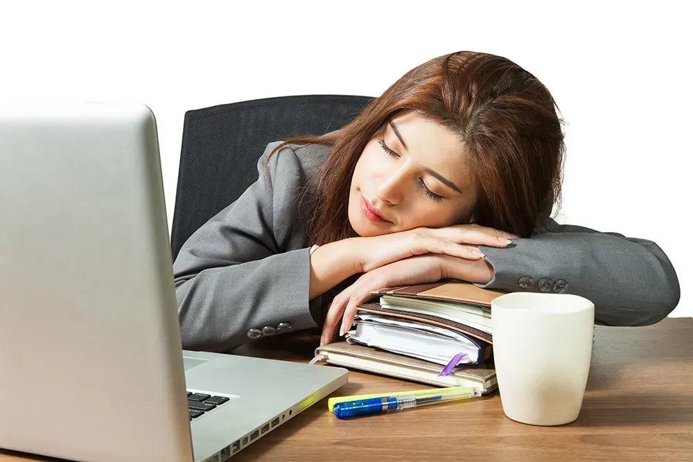 Girl taking a nap over her books.