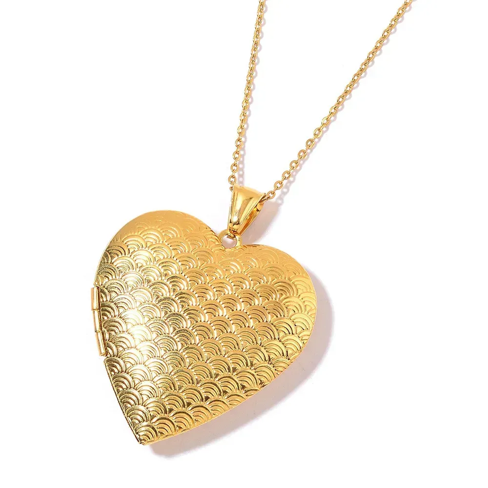 Closeup of gold heart necklace against white background