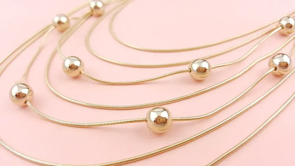 Gold layered necklace with gold beads