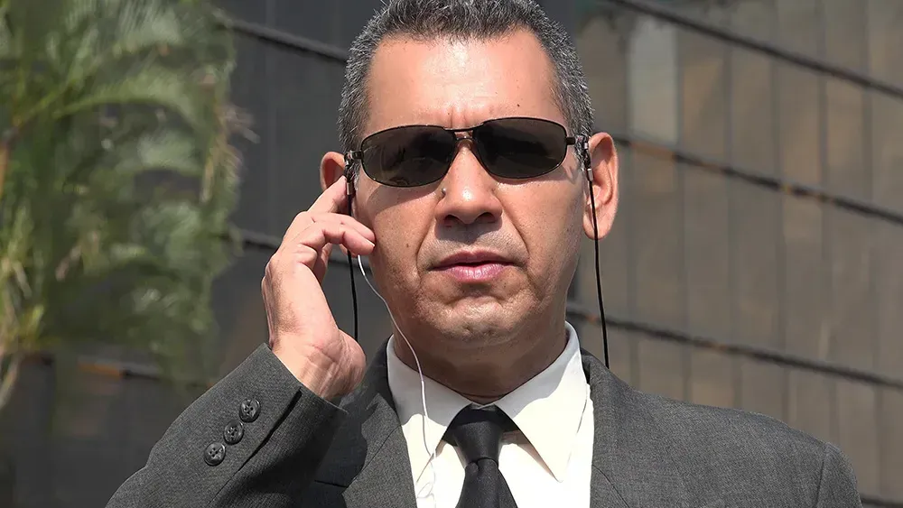 Man dressing up as Agents from Men in Black outside