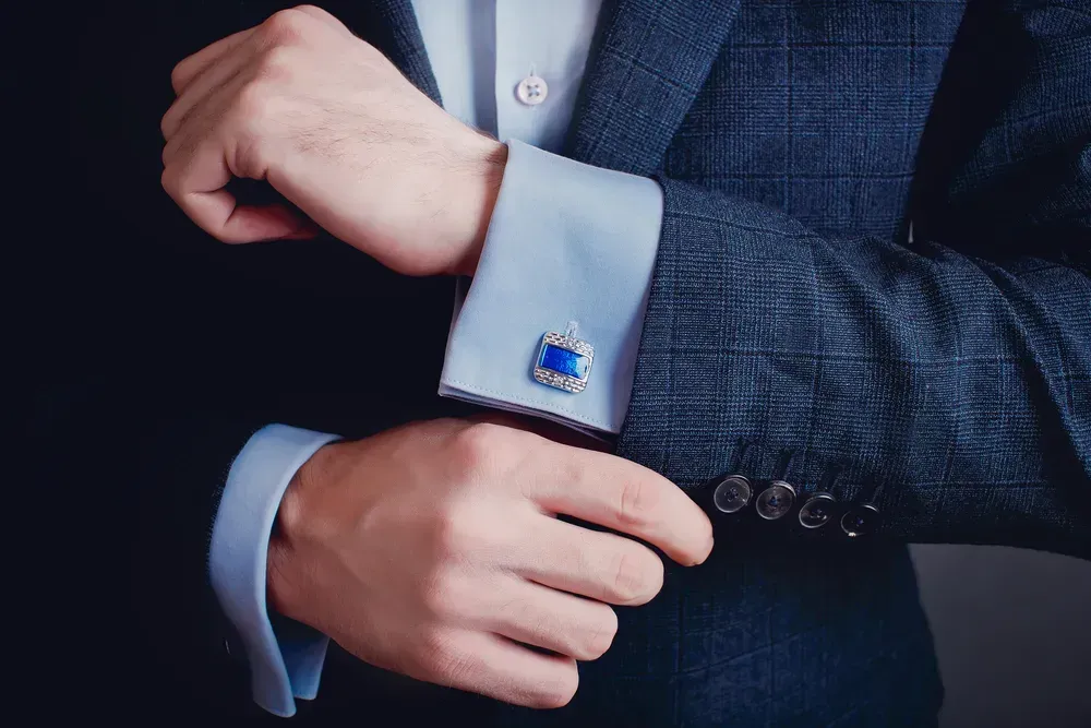 Man tugging onto his cufflinks