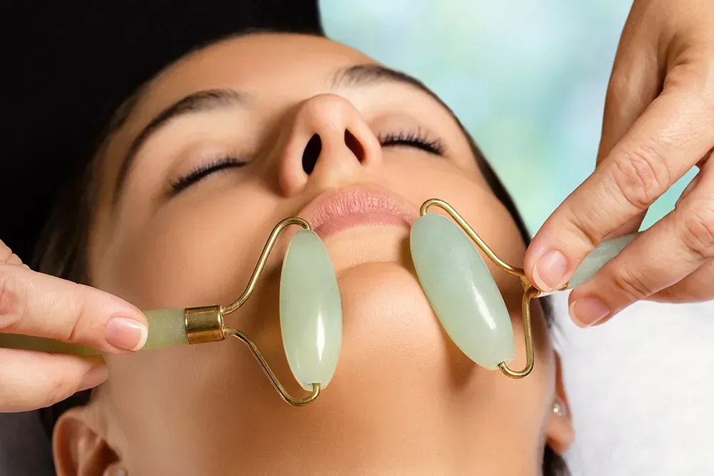 Woman undergoing jade gemstone therapy