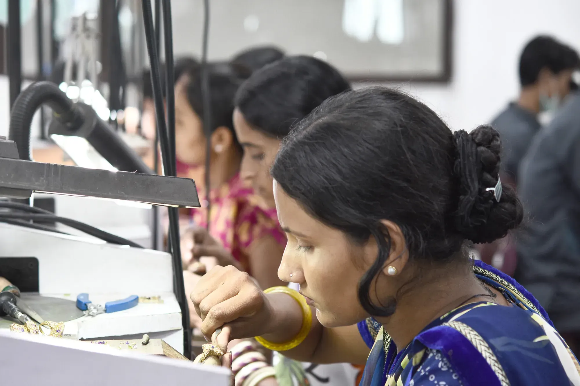 Woman manufacturing jewelry.