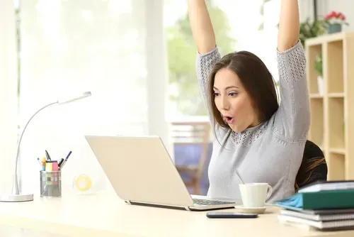 Woman celebrating an online auction win.