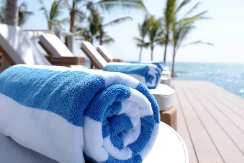 A rolled up blue and white pool towel.