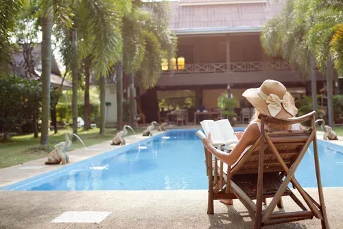 Woman reading by the pool.
