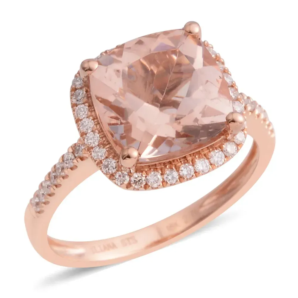 Closeup of rose gold ring with pink morganite gemstone against white background.