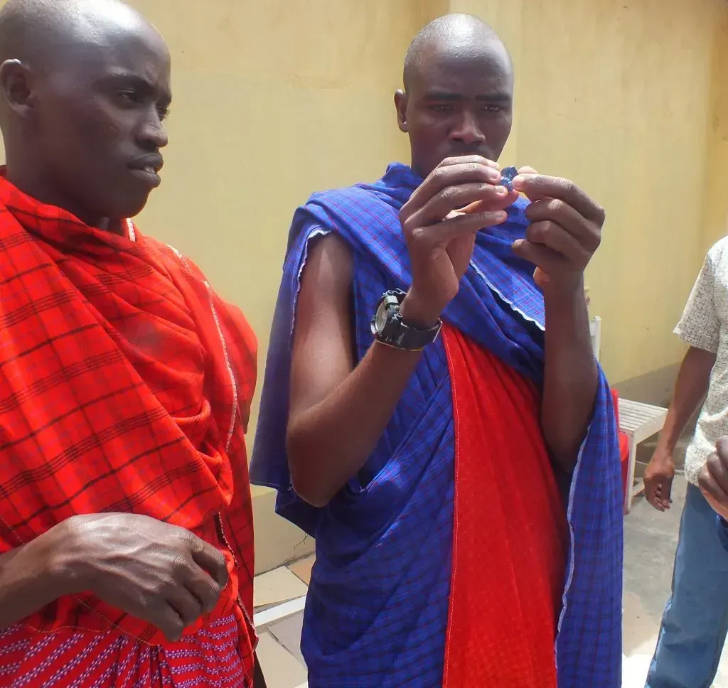 Young Maasai man examines tanzanite.