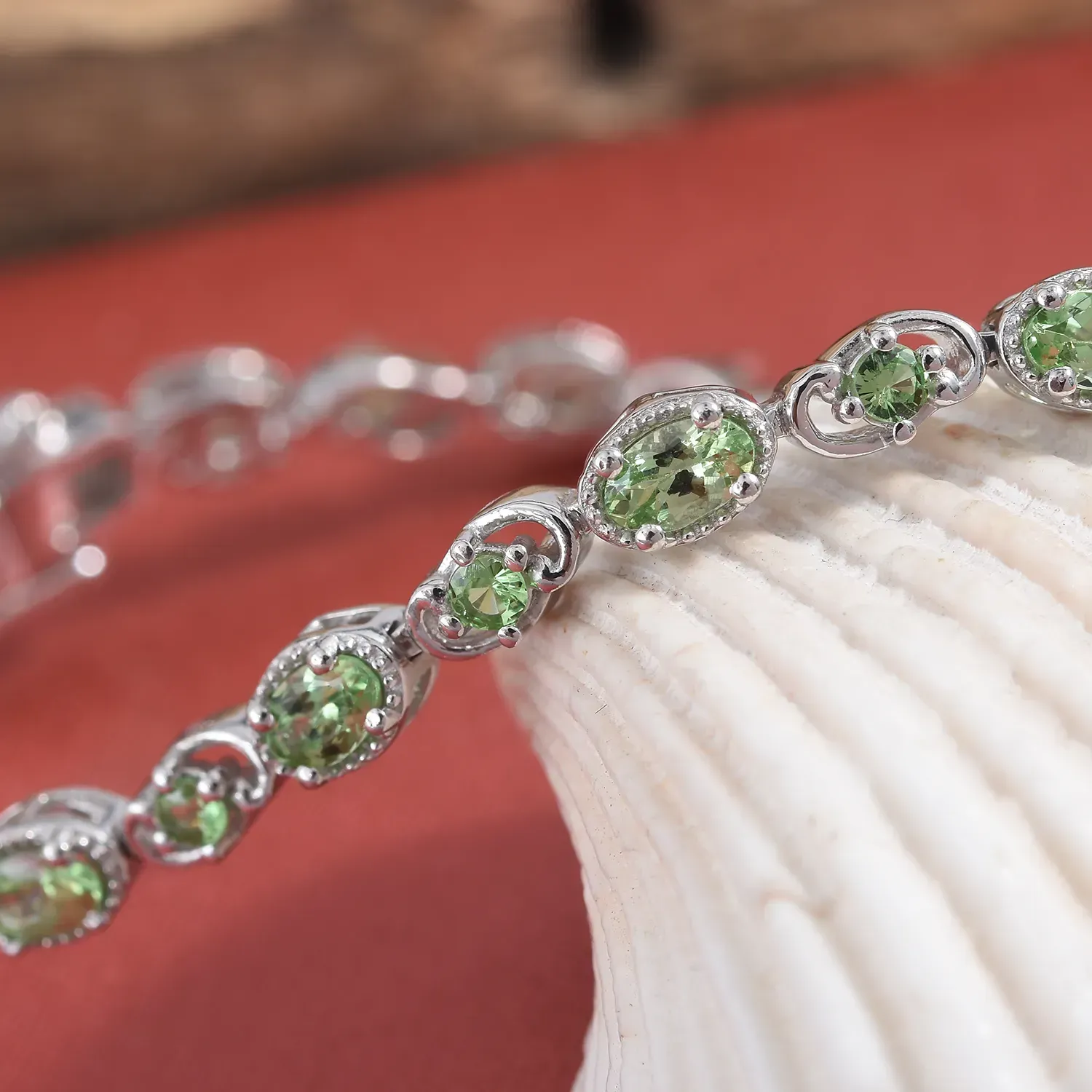Mint garnet line bracelet displayed artfully.