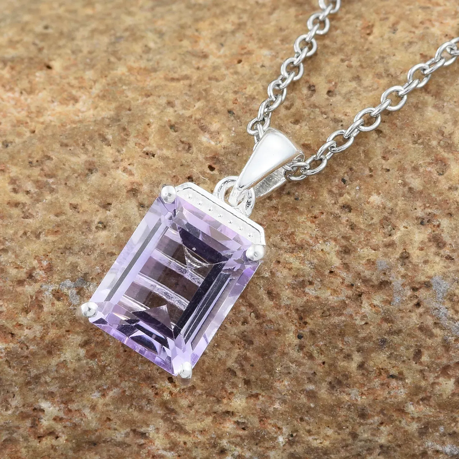 Rose de France pendant draped over granite. 