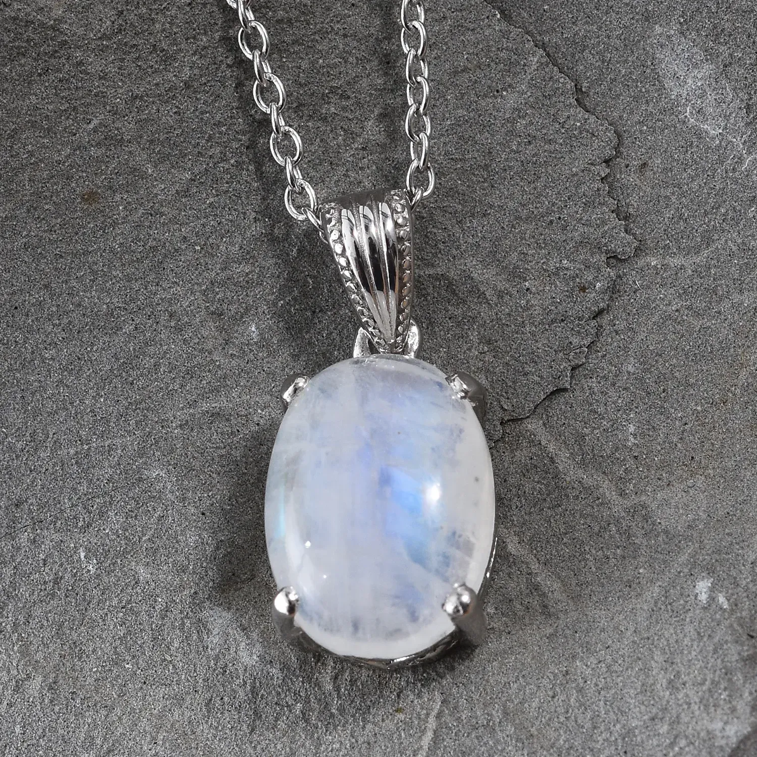 Large white moonstone pendant in simple prong setting.