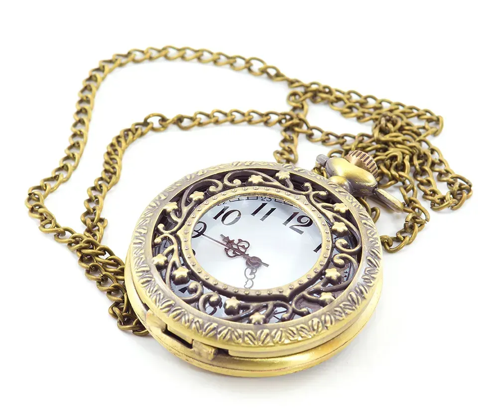 Golden pocket watch against white background.