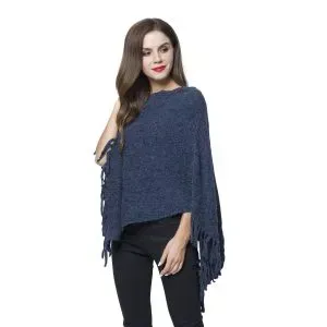 Woman wearing asymmetrical poncho with fringe.