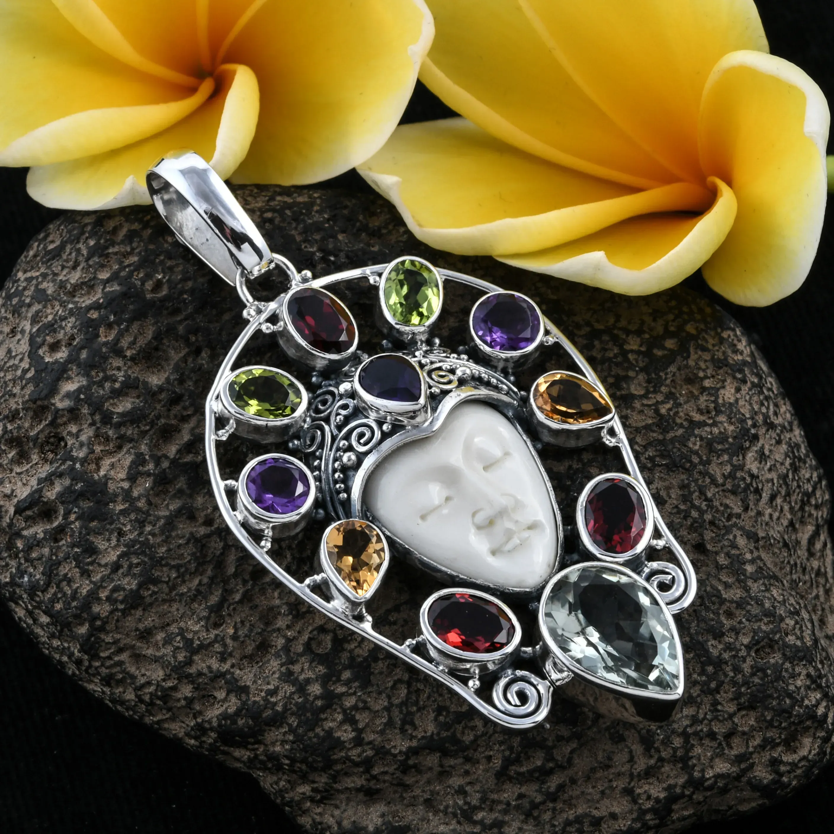 Jeweled Bali jewelry pendant with resting goddess face. 