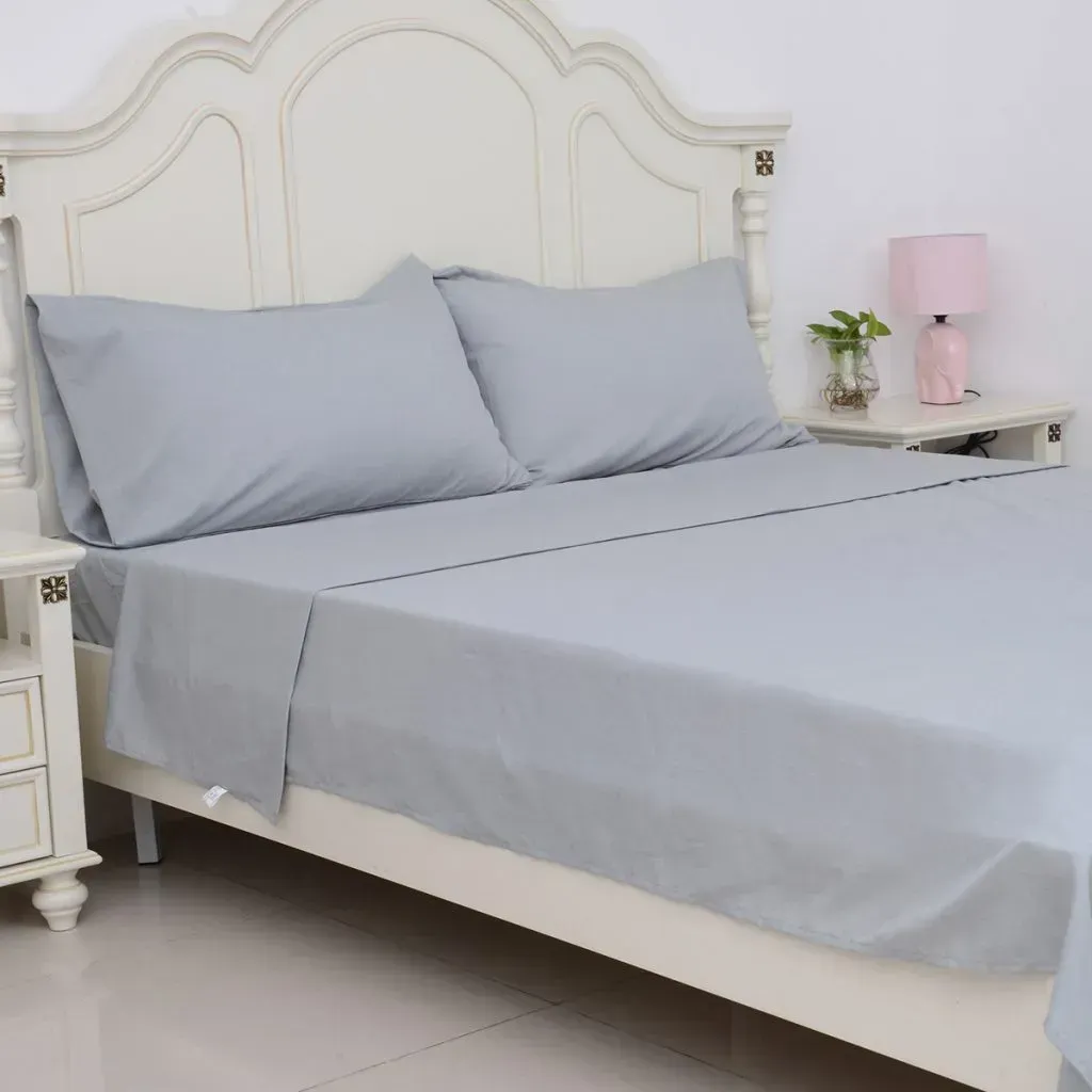 Bed fitted with gray bamboo sheets.