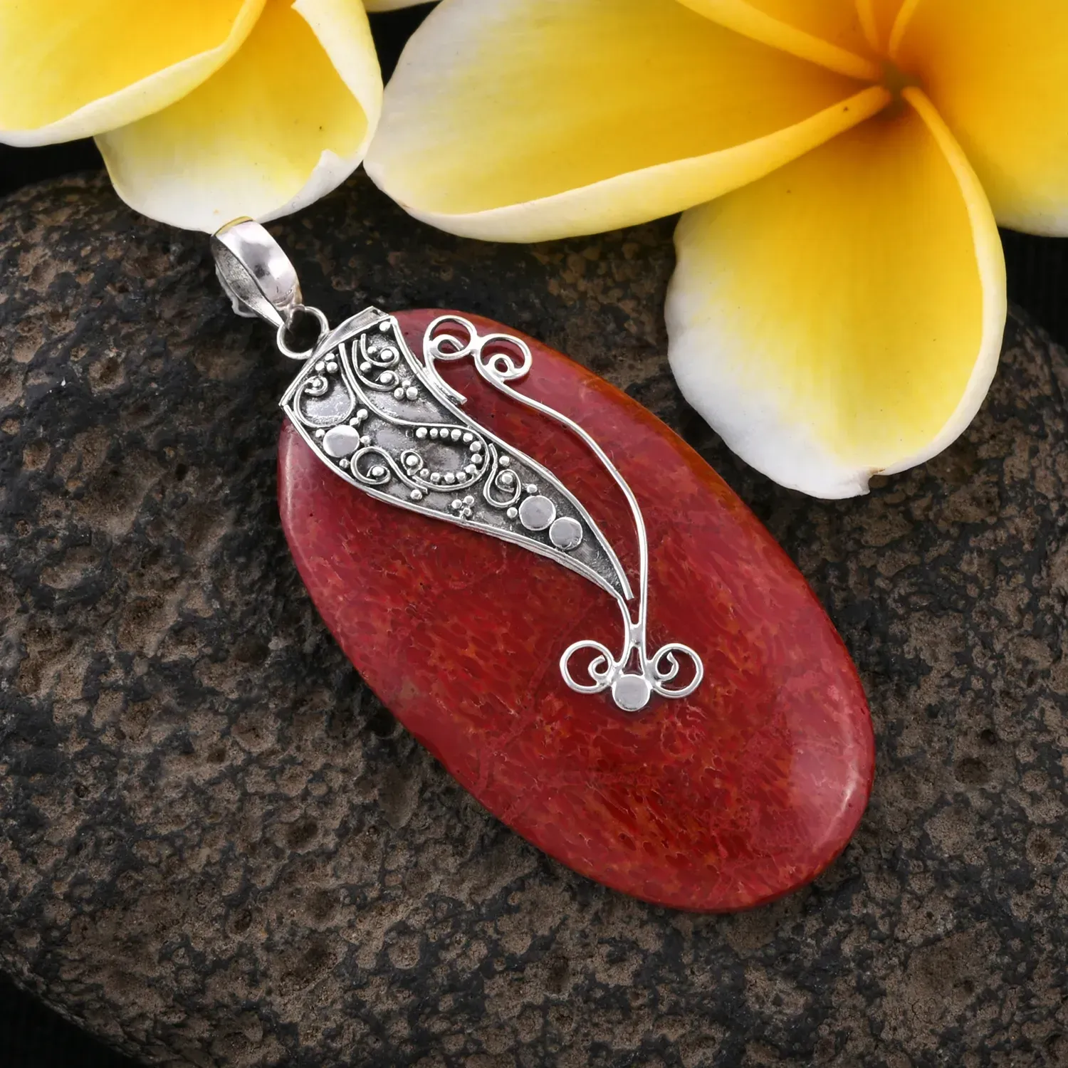 Red coral pendant with sterling silver accents. 