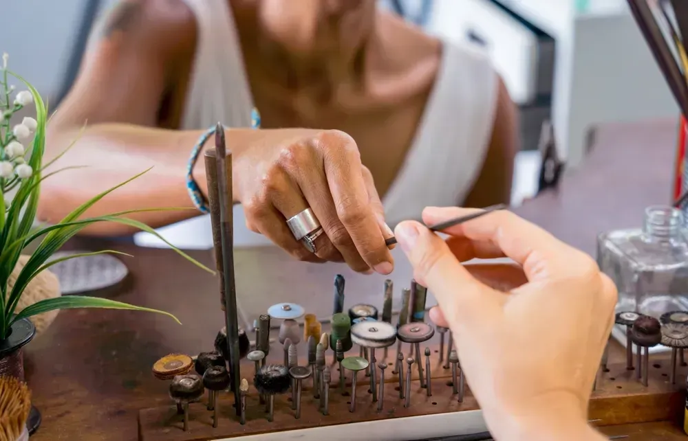 Jewelers working in workshop. 