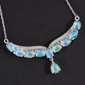 Welo opal Y-necklace against black backdrop.