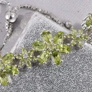 Close-up on peridot bracelet crafted in floral design. 
