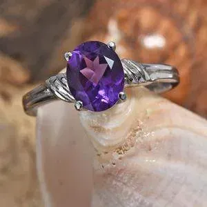 Amethyst ring displayed on shell. 