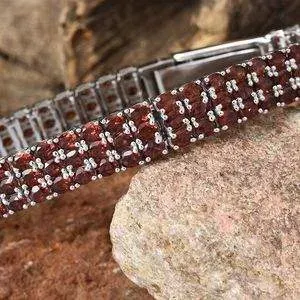 Mozambique garnet bracelet resting on rock. 