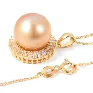 Golden south sea pearl pendant on white background. 