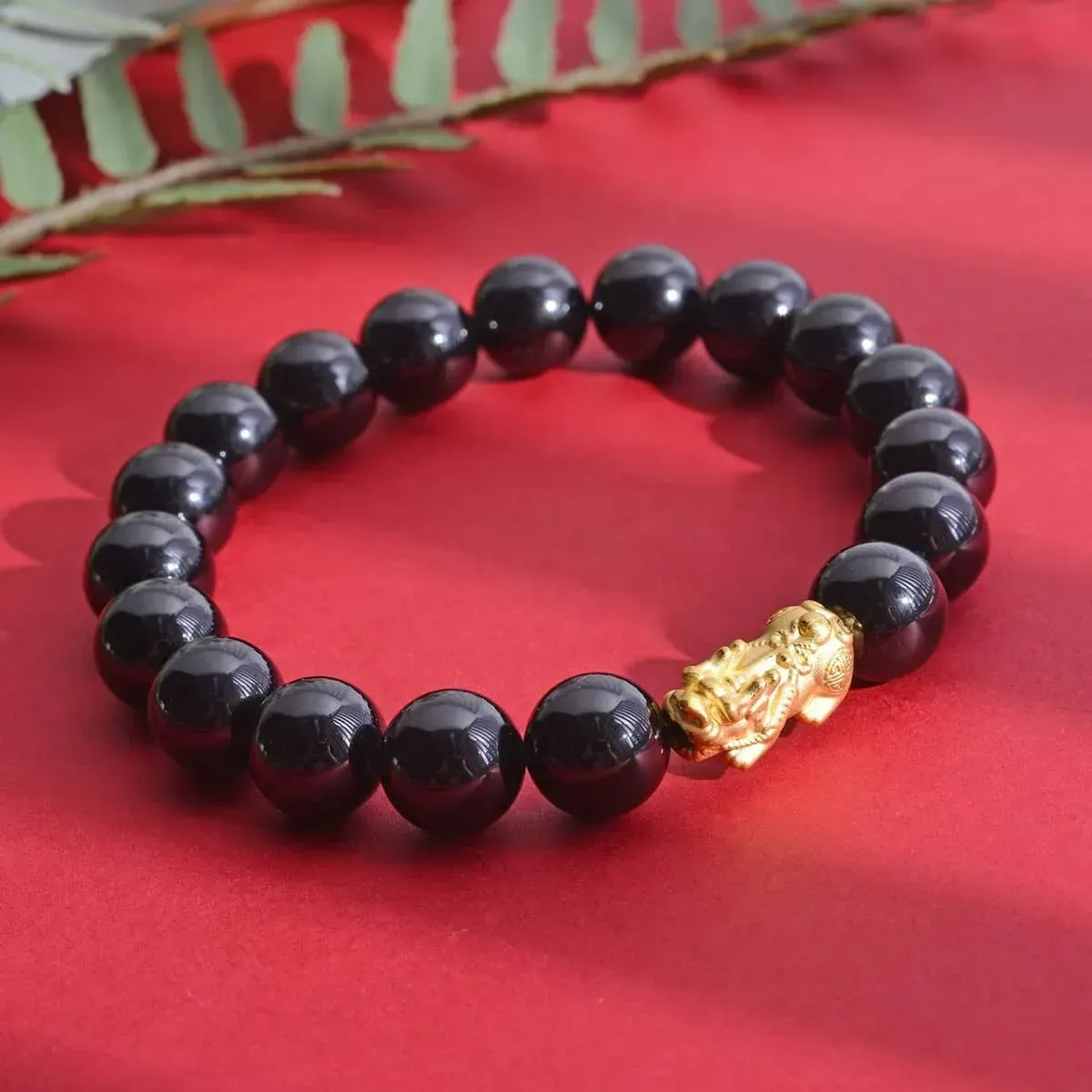 24K Yellow Gold AAAA Black Tourmaline Beaded Stretch Electroform Feng Shui Pi xiu Bracelet,24K Yellow Gold Bracelet, Beads Bracelet, Stretch Bracelet on red background.