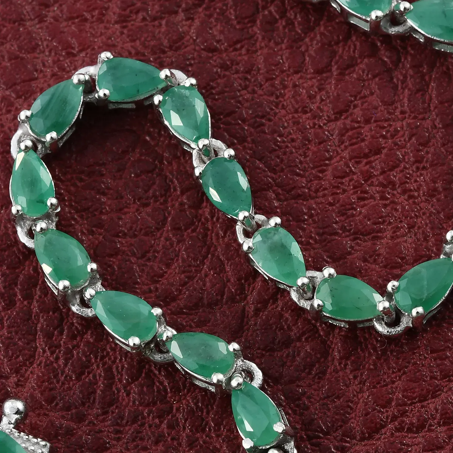 Cancer gemstones - Sokoto emerald line bracelet on red background.