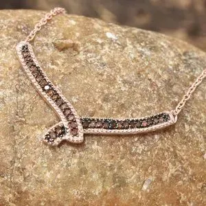 Red diamond necklace draped over stone.