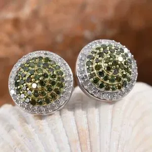 Green diamond earrings displayed on shell. 