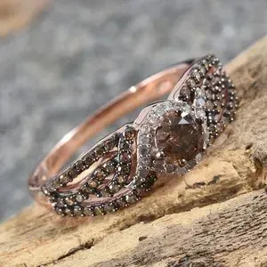 Champagne diamond open shank ring on wood pedestal.