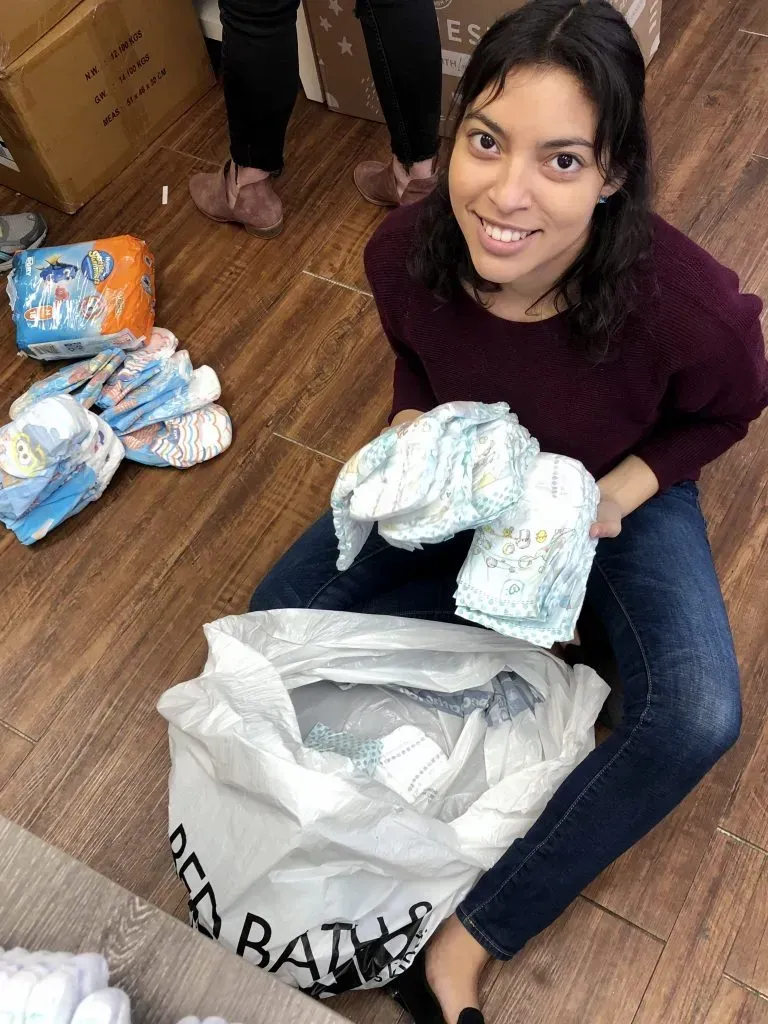 Volunteers pack diapers. 