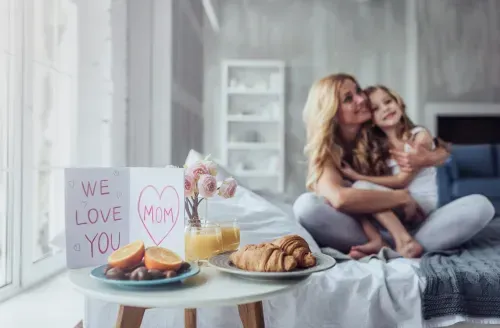 Mother being served breakfast in bed.