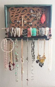 DIY picture frame jewelry holder filled with jewelry.