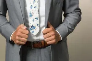 Floral tie with a suit jacket.