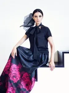 Woman in floral pattern skirt with solid black top. 