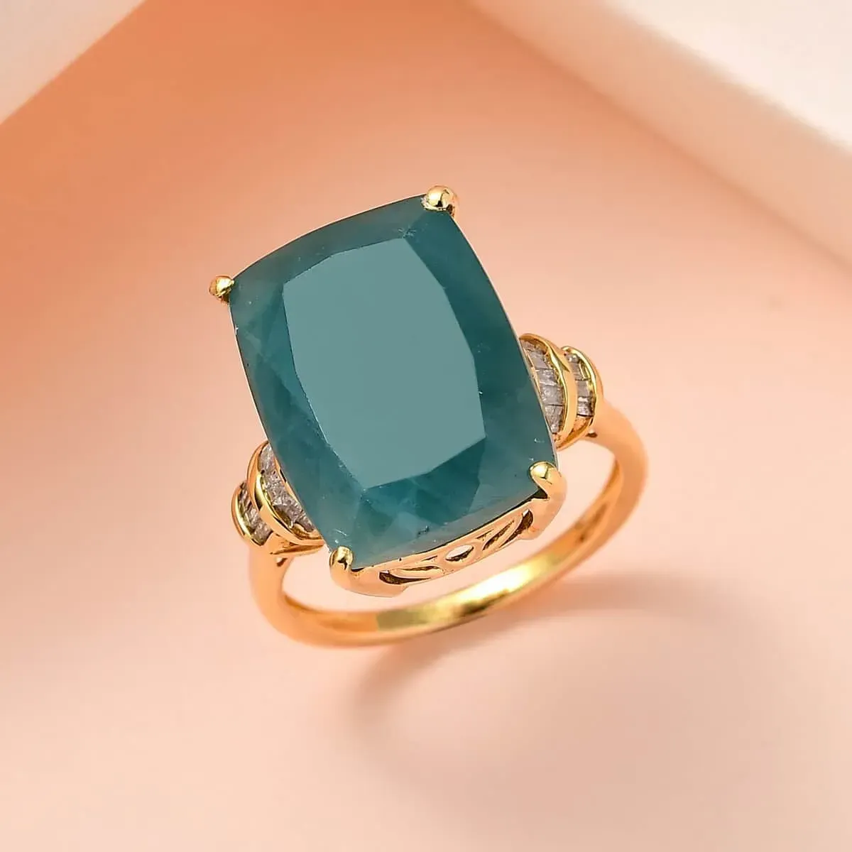 Premium Grandidierite and Diamond Ring in Vermeil Yellow Gold Over Sterling Silver displayed on on a soft peach background.