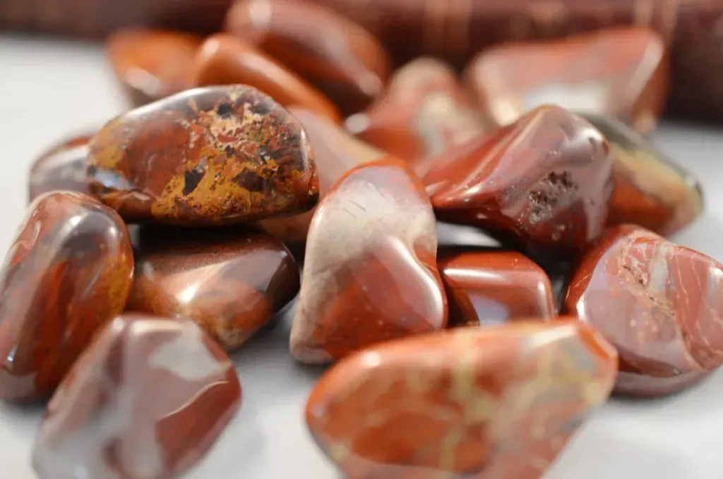 Tumbled brownish orange jasper stones. 