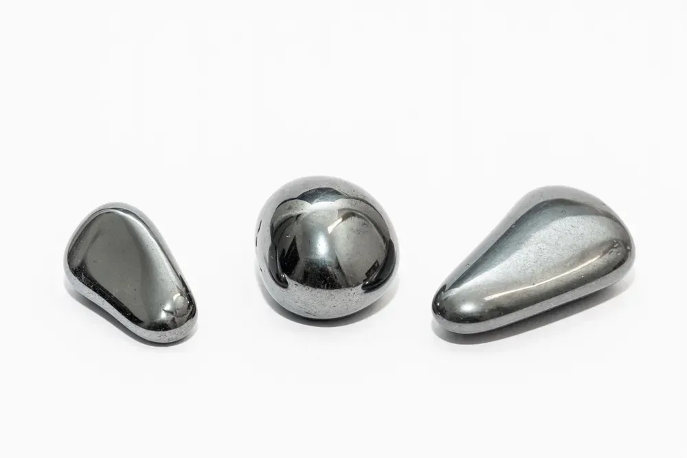 Polished hematite crystals on white background.