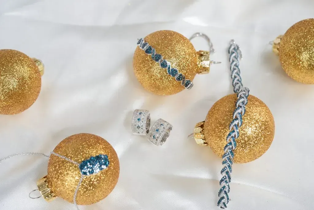 Flay lay of jewelry with Christmas ornaments.